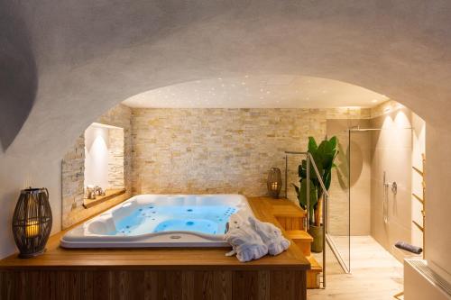 ein Bad mit einer großen Badewanne in einem Zimmer in der Unterkunft Borgo Cantagallo Casa Ofelia in Tremosine sul Garda