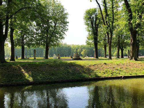 a pond in a park with trees and grass at Hotel No. 11 in Lüdinghausen
