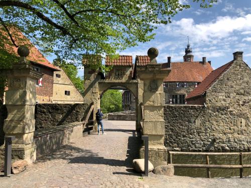 a person walking through an archway in a castle at Hotel No. 11 in Lüdinghausen