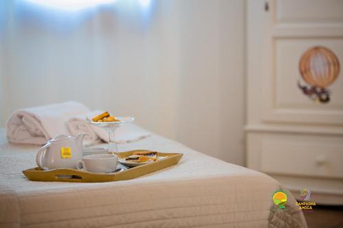 a tray with food and drinks on a bed at Agriturismo Ai Carpini in Marcon