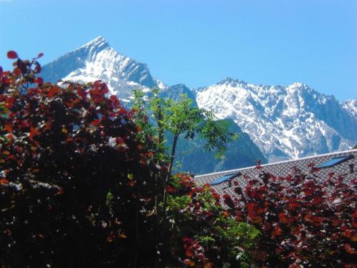 a view of snow covered mountains from a roof at Ferienwohnung Angie in Garmisch-Partenkirchen