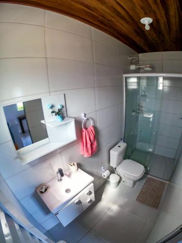 a bathroom with a shower and a toilet and a sink at Casa dos Tubarões in Fernando de Noronha