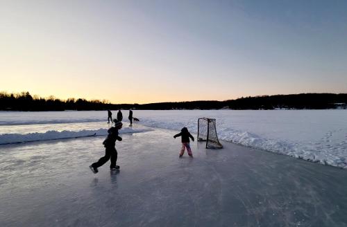 a group of people playing on the ice at Bonnie View Inn in Haliburton