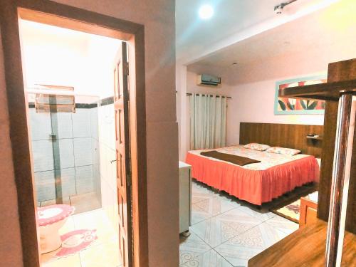 a bedroom with a bed and a bathroom at Guajará Palace Hotel in Porto Velho