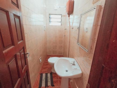 a bathroom with a toilet and a sink at Guajará Palace Hotel in Porto Velho