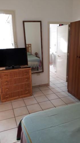 a living room with a tv and a mirror at Villa nel Salento - Casa Maria e Casa Glory in Porto Cesareo