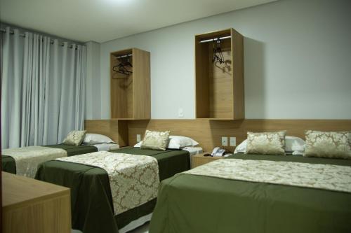 Giường trong phòng chung tại Hotel Araçás