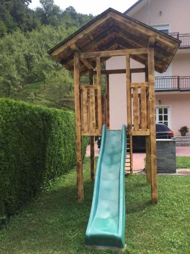 a slide in a gazebo in a yard at Vila Jakovljević in Jošanička Banja