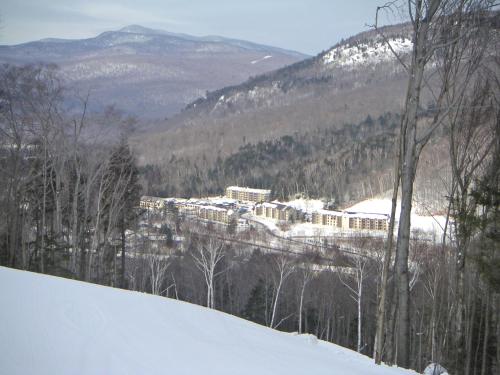 a snow covered mountain with a town in the distance at InnSeason Resorts Pollard Brook in Lincoln
