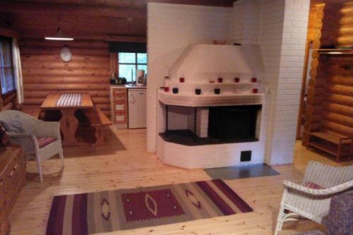 a kitchen with an oven in the middle of a room at Holiday Cabin Kerimaa 121 in Savonlinna