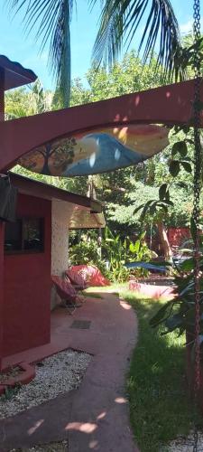 a surfboard hanging off the side of a house at Massai Apartments in Playa Flamingo