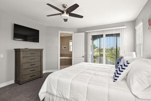 a bedroom with a bed and a ceiling fan at Fortebello Beachside - 164 in Indian Harbour Beach