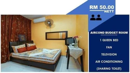 a bedroom with a bed and a tv in a room at Ghazrins Hotel Dataran Larkin in Johor Bahru