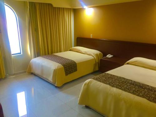 Säng eller sängar i ett rum på Hotel Villas Dali Veracruz