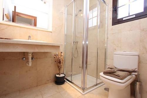 a bathroom with a shower and a toilet and a sink at Villa Emma Playa Blanca in Playa Blanca