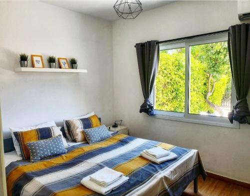 a bedroom with a bed with towels on it at Prima Casa 005 in Paphos City