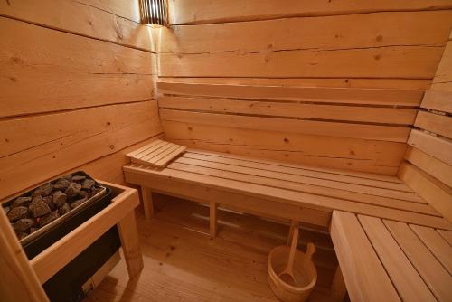 a wooden sauna with a bench in the middle at Rekreační domek Kobylnice Lipno in Lipno nad Vltavou