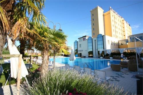 a resort with a swimming pool and some buildings at Zanhotel Centergross in Bentivoglio