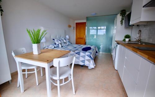 a kitchen and a bedroom with a bed and a table at Atlantic Sea in Gran Tarajal