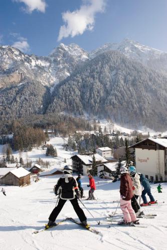 a group of people on skis in the snow at Familienhotel Lagant in Brand