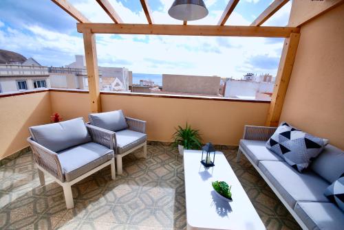 a patio with two chairs and a table on a balcony at Atlantic Sea in Gran Tarajal