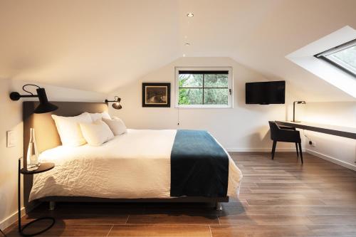 מיטה או מיטות בחדר ב-Vertes Feuilles