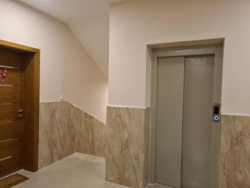 a hallway with a sliding door in a house at Apartman Ogi in Nova Varoš