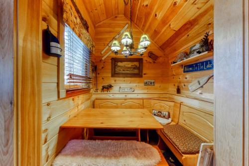 a dining room with a wooden table in a cabin at Cozy in the Woods in Madison