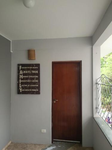 a door in a building with a sign on the wall at Pousada Sitieto Voitov in Aluminio