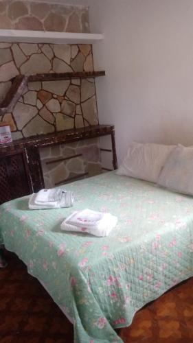 a bedroom with a bed with two towels on it at Aconchego em Garanhuns in Garanhuns