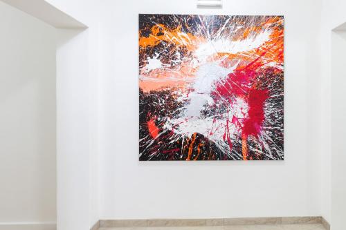 a painting hanging on a wall in a room at STAY@MA Boardinghouse Mannheim in Mannheim