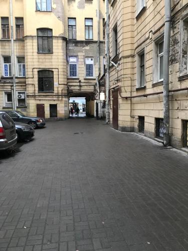 an empty parking lot in a city with buildings at Апартаменты на Гончарной,11 in Saint Petersburg