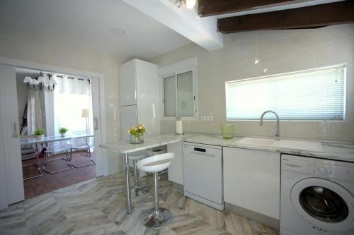 a kitchen with a sink and a washing machine at Annette in Albir