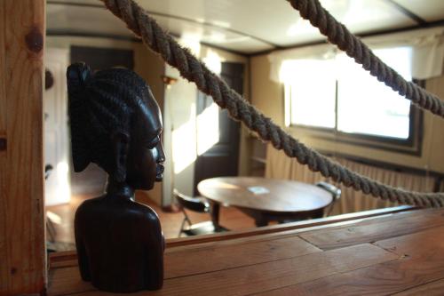 a statue of a girl on a rope in a room at Péniche Espoir in Avignon