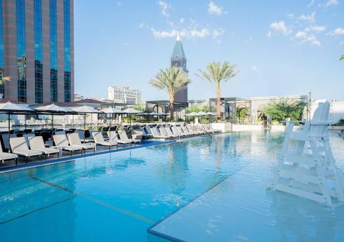 a swimming pool with chairs and a ladder in a city at The Venetian® Resort Las Vegas in Las Vegas