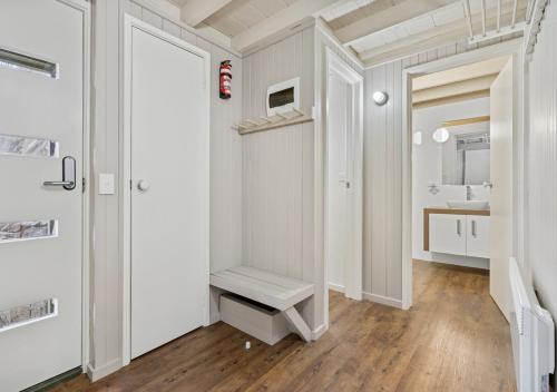 a white bathroom with a sink and a mirror at Diamantina in Dinner Plain