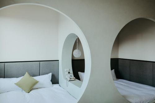 Una cama o camas en una habitación de Xien Shi Homestay