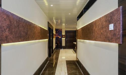 a hallway with brown and white walls and a hallway with a door at Treebo Hotel A1 in Nagpur