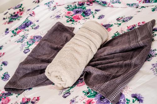 a pair of socks on a bed with flowers at Dwa Dęby in Lubawka