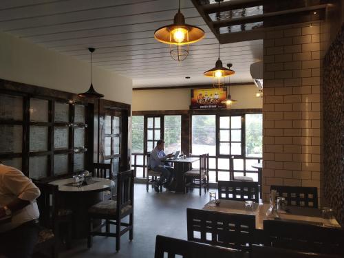 a man sitting at a table in a restaurant at Hotel Bikram-A Boutique Hotel in Tezpur