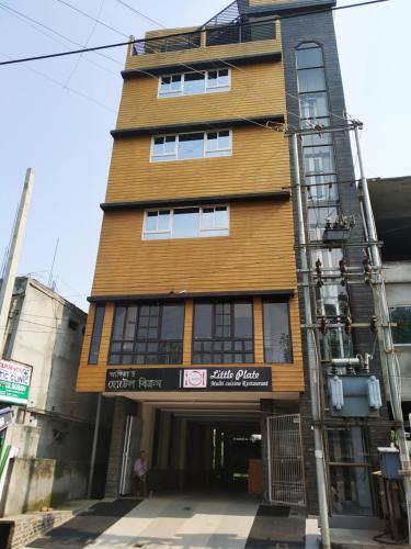 a tall wooden building with a sign on it at Hotel Bikram-A Boutique Hotel in Tezpur