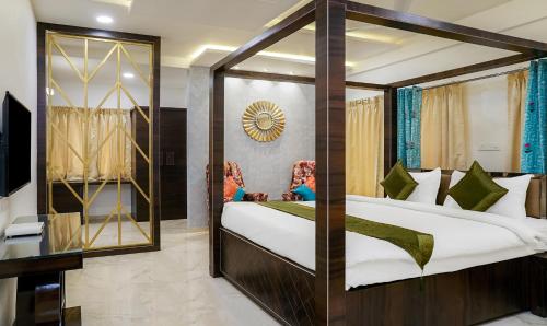 a bedroom with a large bed and a mirror at Treebo Hotel A1 in Nagpur