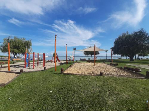 a park with a playground with a swing set at Timbi Vendégház in Vonyarcvashegy