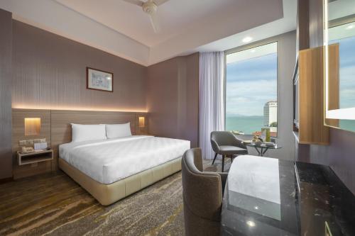 a hotel room with a bed and a desk at Cititel Penang in George Town