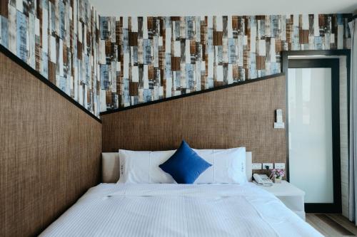 Una cama o camas en una habitación de Xien Shi Homestay