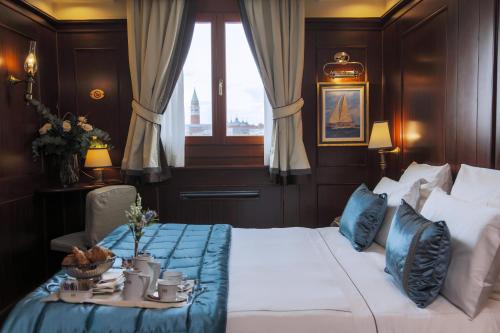 a hotel room with two beds and a table at Hotel Bucintoro in Venice