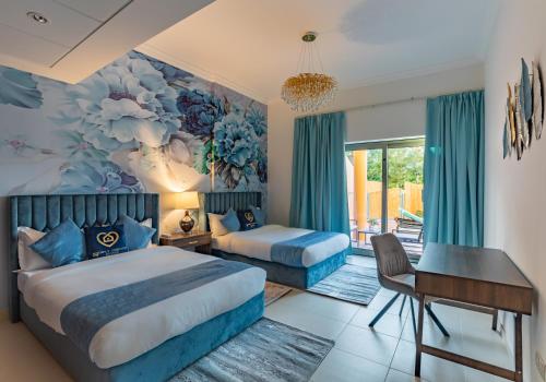 a bedroom with two beds and a desk at Exclusive Escapes Private Pool Homes and Villas by GLOBALSTAY Holiday Homes in Dubai