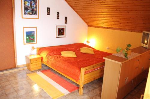 a bedroom with a bed and a tv in it at Mekina Guesthouse in Maribor