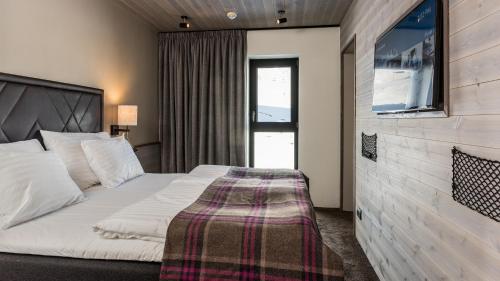 Кровать или кровати в номере Langley Hôtel Tignes 2100