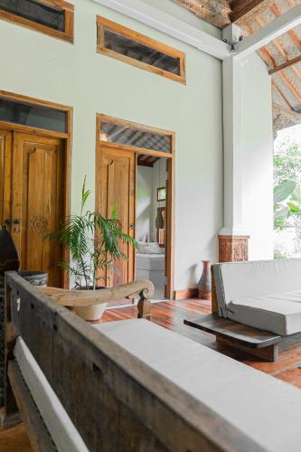 a room with a bed and a wooden floor at Adara Homestay in Banyuwangi